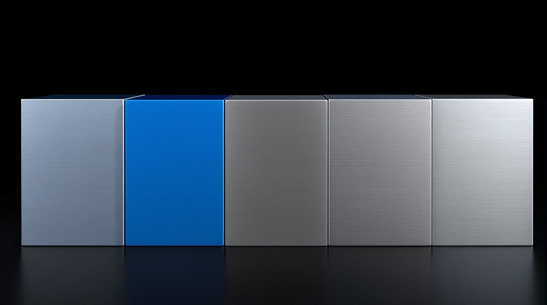 Row of machined metal plates with differently profiled edges, one anodised blue